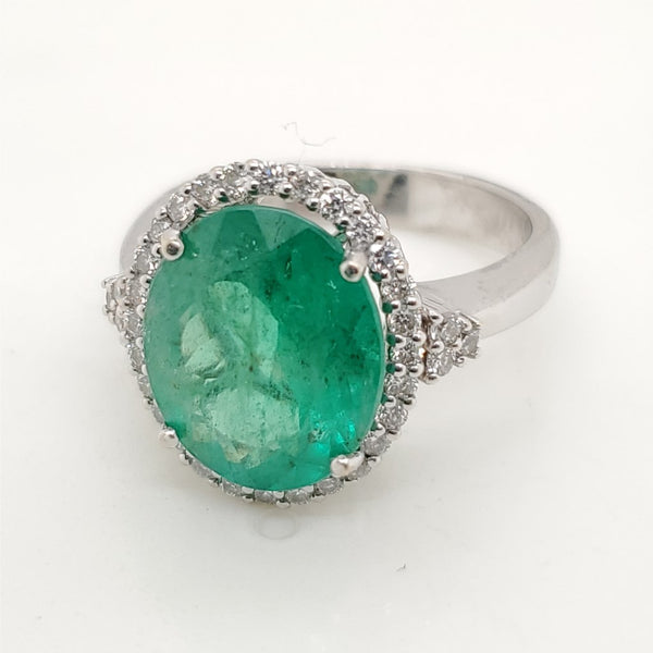 14kt white gold 4.00 carat oval emerald and diamond halo ring.