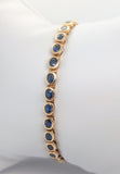 14K Yellow Gold Tennis Style Bracelet with Bezel Set Royal Blue Oval Sapphires